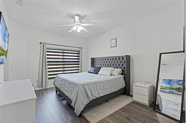 bedroom with ceiling fan and dark hardwood / wood-style floors