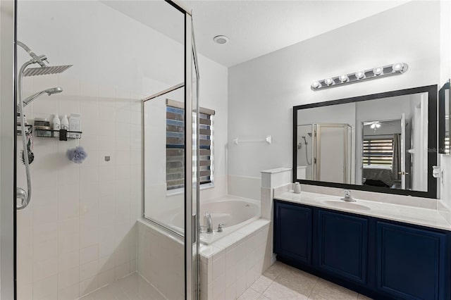 bathroom featuring tile patterned flooring, vanity, and separate shower and tub