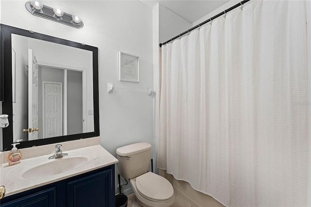 full bathroom with vanity, shower / tub combo, and toilet