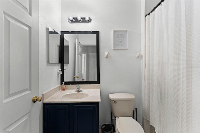 bathroom featuring vanity, a shower with shower curtain, and toilet