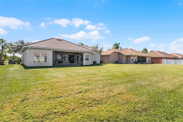 rear view of house with a yard