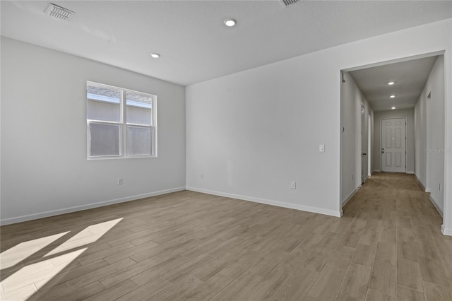 empty room with light hardwood / wood-style floors