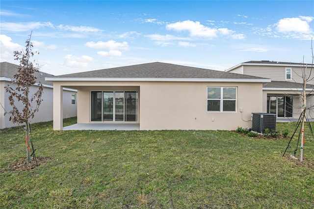 back of property with a patio, a lawn, and central air condition unit