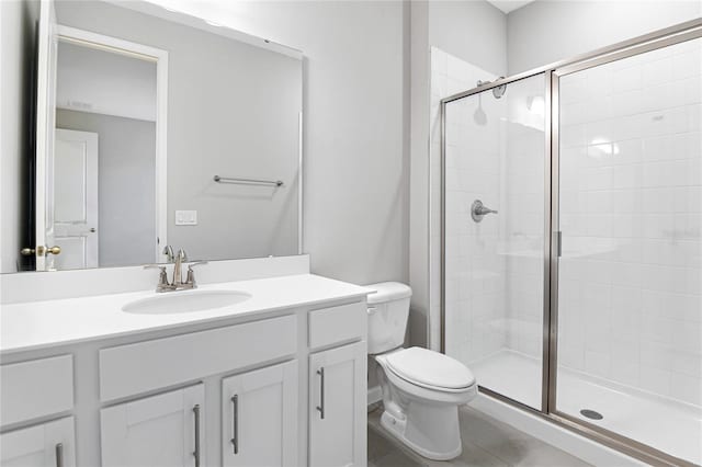 bathroom with toilet, vanity, and walk in shower