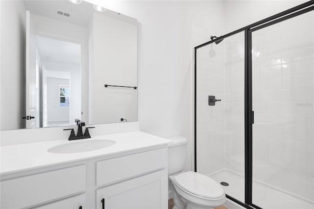 bathroom with toilet, a stall shower, visible vents, and vanity