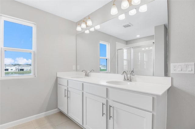 bathroom with tile patterned flooring, vanity, and a shower with shower door