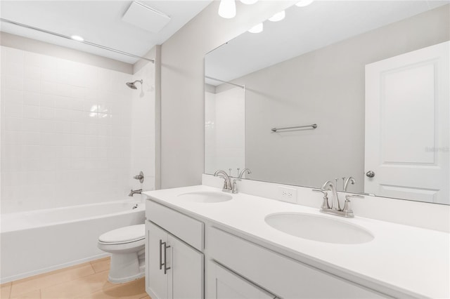 full bathroom with tiled shower / bath combo, vanity, tile patterned floors, and toilet