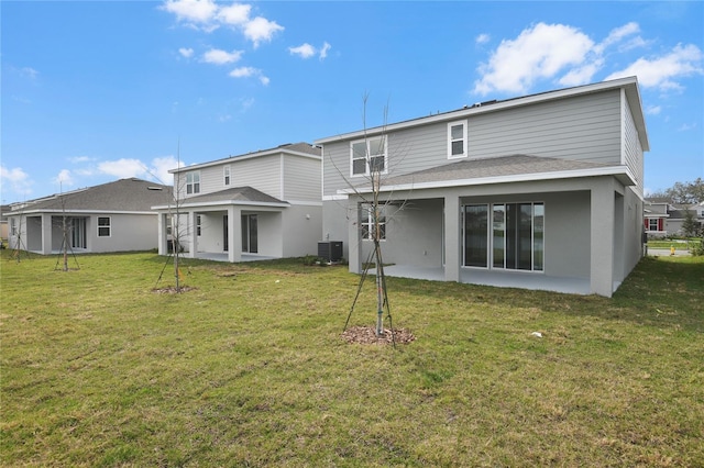 back of house featuring a yard, a patio area, and central air condition unit