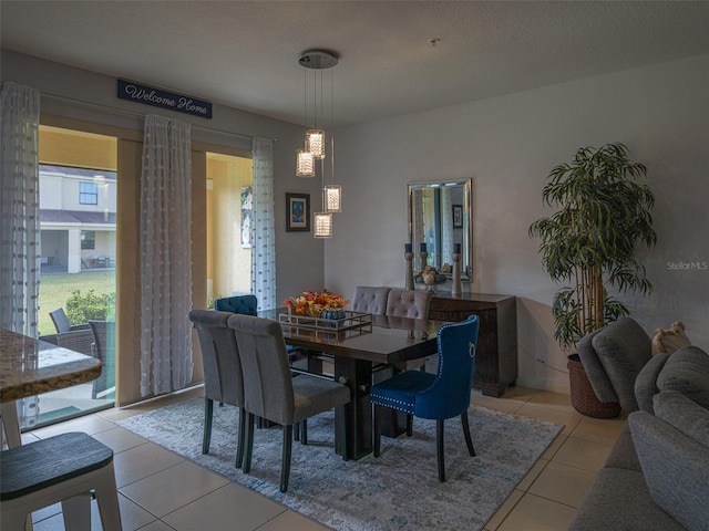 tiled dining space featuring a textured ceiling