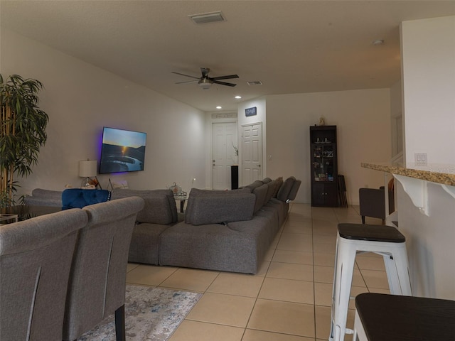 tiled living room featuring ceiling fan