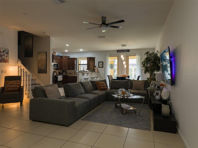 tiled living room featuring ceiling fan