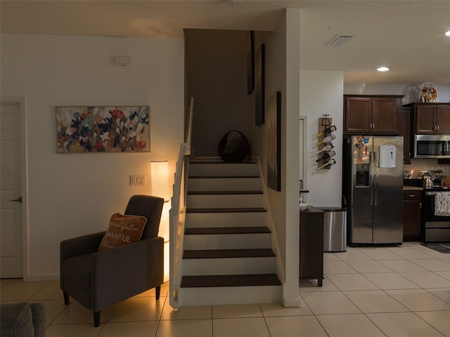 staircase featuring tile patterned flooring