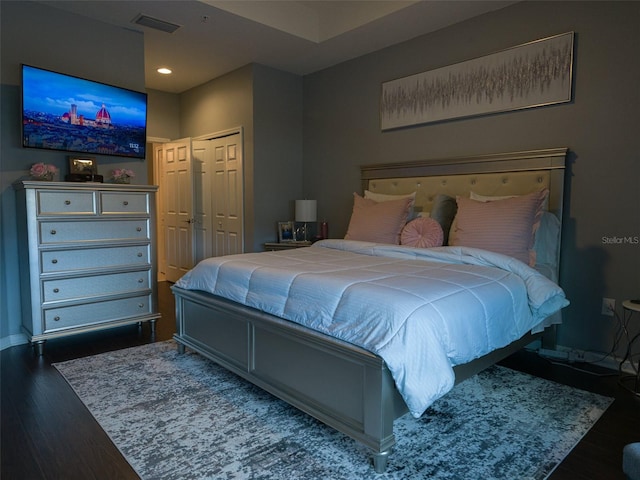 bedroom with a closet and dark hardwood / wood-style floors