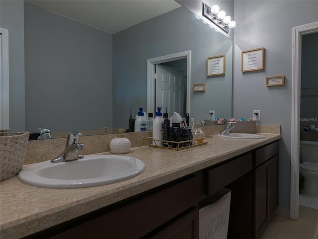 bathroom with tile patterned floors, vanity, and toilet