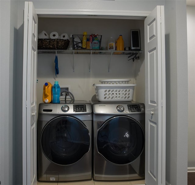 washroom with tile patterned flooring and washer and clothes dryer