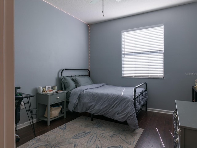 bedroom featuring dark hardwood / wood-style floors and ceiling fan