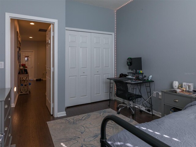 bedroom featuring dark hardwood / wood-style flooring and a closet