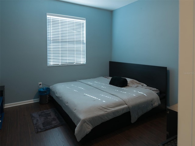 bedroom with dark hardwood / wood-style flooring