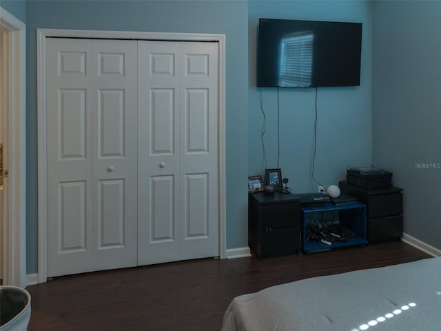 bedroom featuring dark hardwood / wood-style flooring and a closet