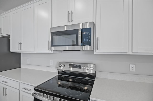 kitchen with appliances with stainless steel finishes and white cabinets