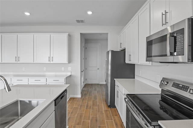 kitchen with white cabinetry, sink, and stainless steel appliances