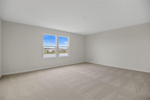 spare room with light colored carpet