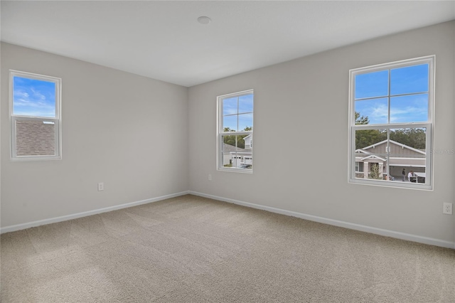 carpeted empty room with a wealth of natural light