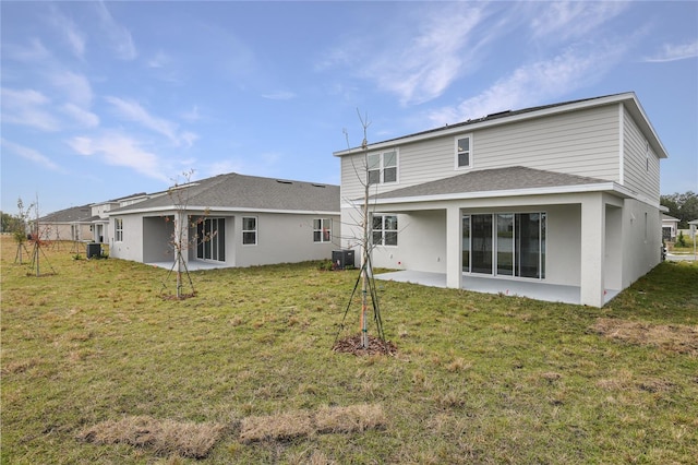 back of property with a patio, a yard, and central air condition unit