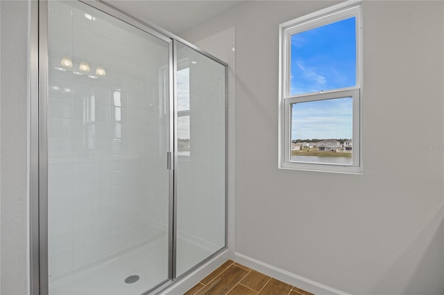 bathroom featuring a shower with shower door