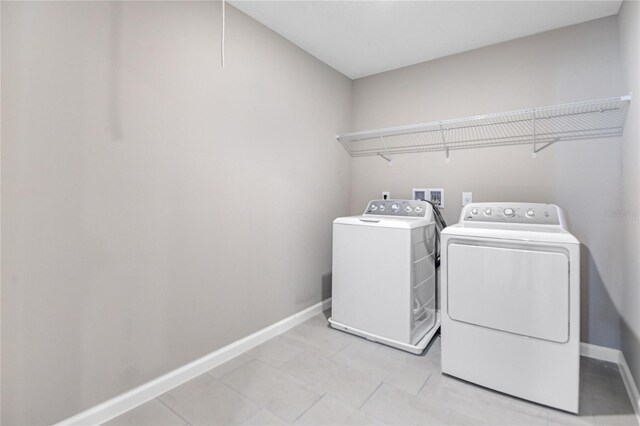 clothes washing area featuring separate washer and dryer