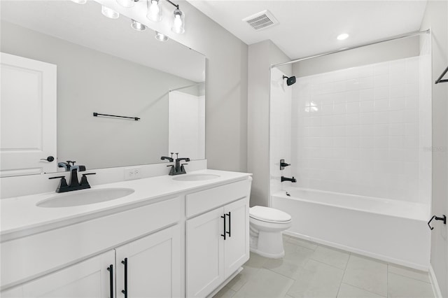 full bathroom with tiled shower / bath combo, vanity, tile patterned flooring, and toilet