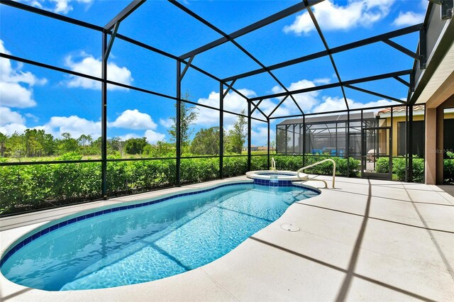 view of pool with glass enclosure, an in ground hot tub, and a patio