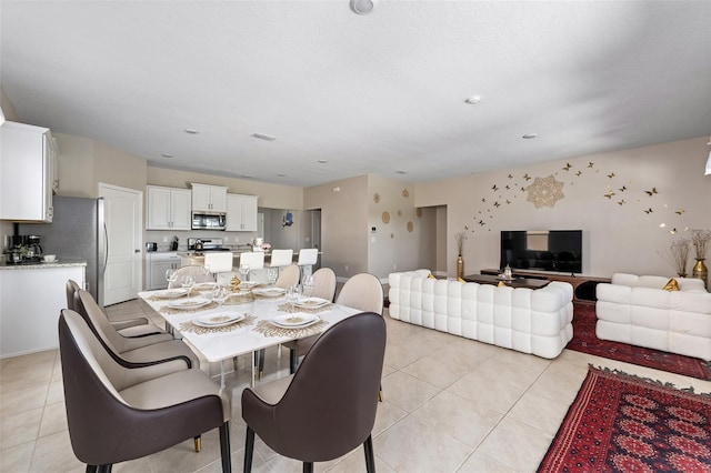 dining space with light tile patterned floors