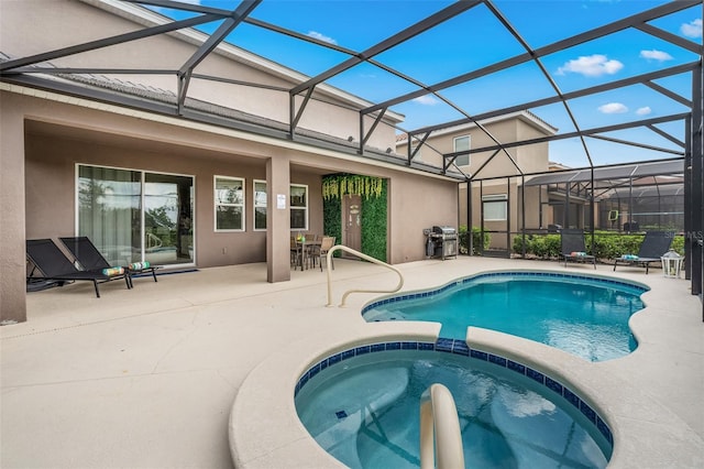 view of swimming pool with a patio area, an in ground hot tub, glass enclosure, and a grill