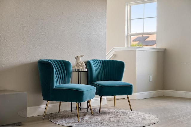 sitting room with hardwood / wood-style flooring