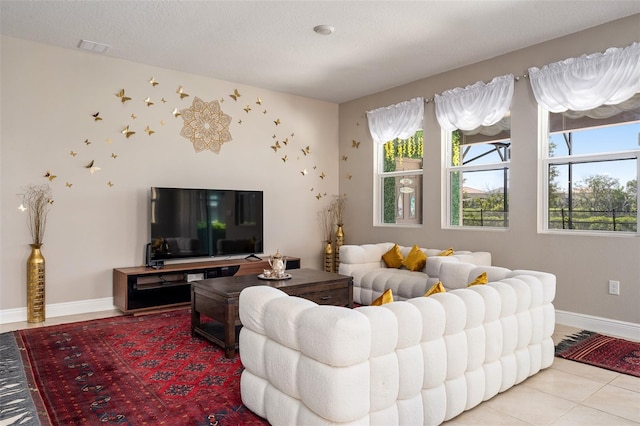 tiled living room featuring a textured ceiling