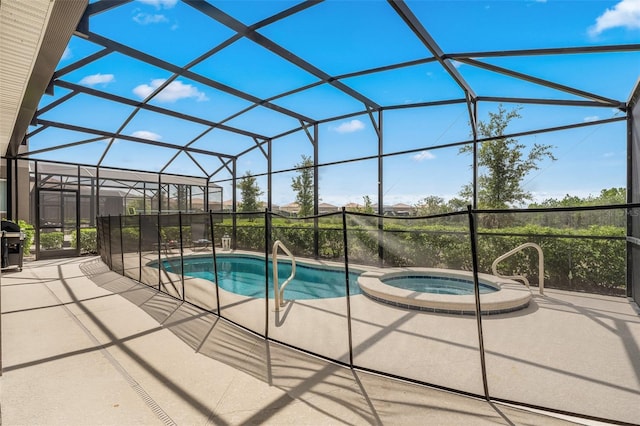 view of pool with a lanai, a patio, and an in ground hot tub