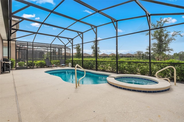 view of pool with an in ground hot tub, area for grilling, a patio area, and a lanai