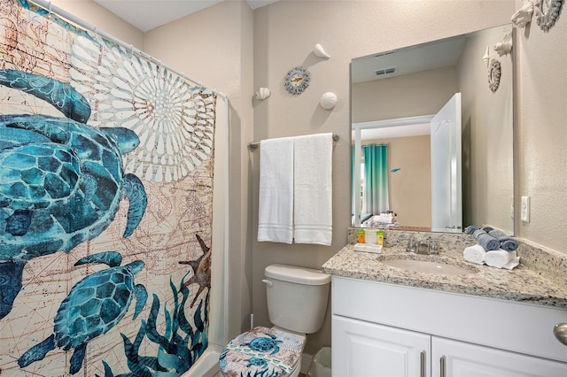 bathroom featuring vanity and toilet