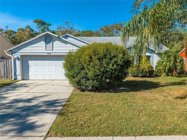 ranch-style home with a garage and a front lawn