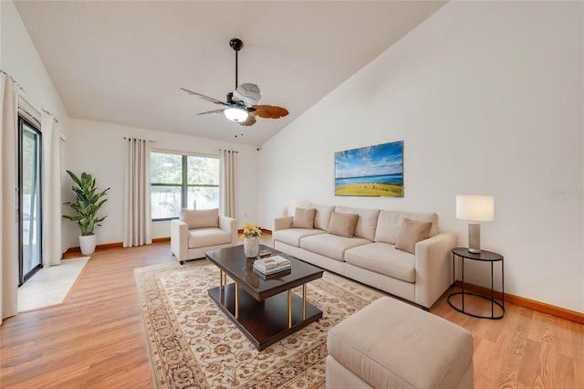 living room featuring ceiling fan, light hardwood / wood-style floors, and high vaulted ceiling