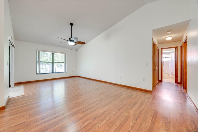 spare room with lofted ceiling, ceiling fan, and light wood-type flooring