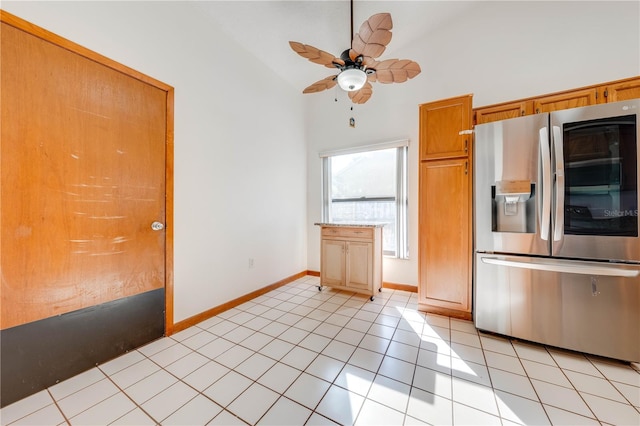 kitchen with ceiling fan, light tile patterned floors, stainless steel refrigerator with ice dispenser, and high vaulted ceiling