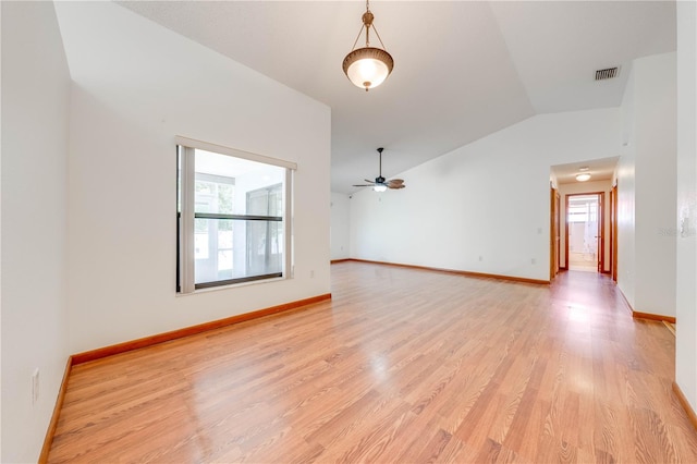 spare room with ceiling fan, vaulted ceiling, and light hardwood / wood-style flooring