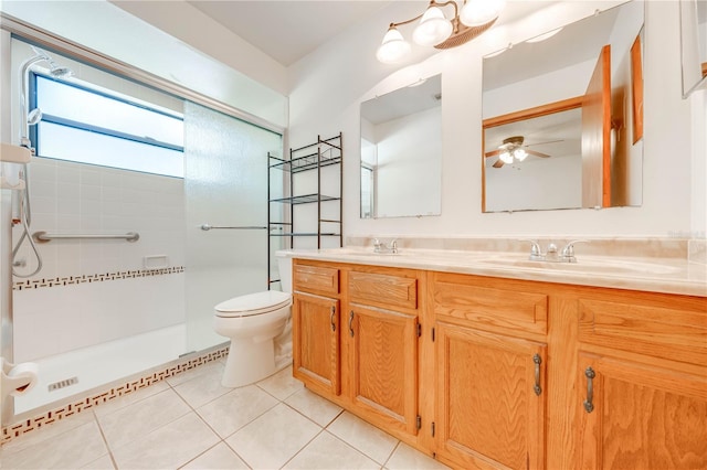 bathroom featuring vanity, tile patterned flooring, ceiling fan, toilet, and tiled shower