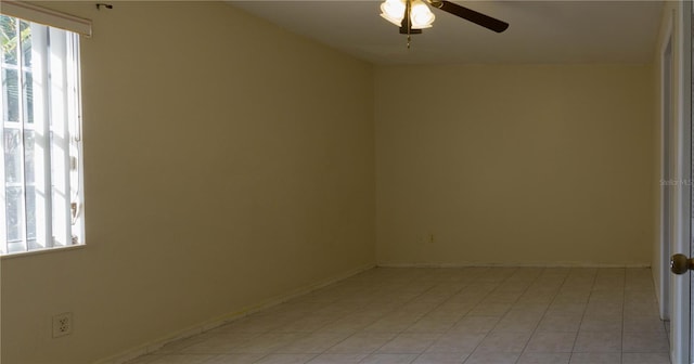 empty room featuring ceiling fan and a healthy amount of sunlight