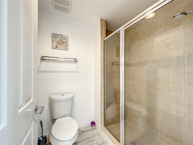 7510 Seven Eagles Way Unit 7510, Reunion, FL 34747 - bathroom with toilet, a shower stall, wood finished floors, and baseboards