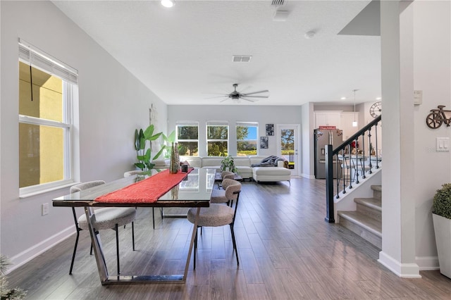 dining space with hardwood / wood-style flooring and ceiling fan