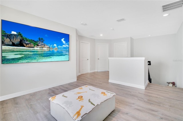 home theater with light wood-type flooring