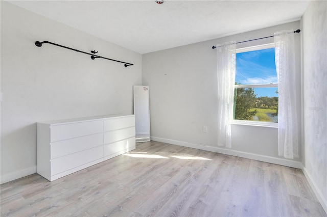 empty room with light hardwood / wood-style flooring